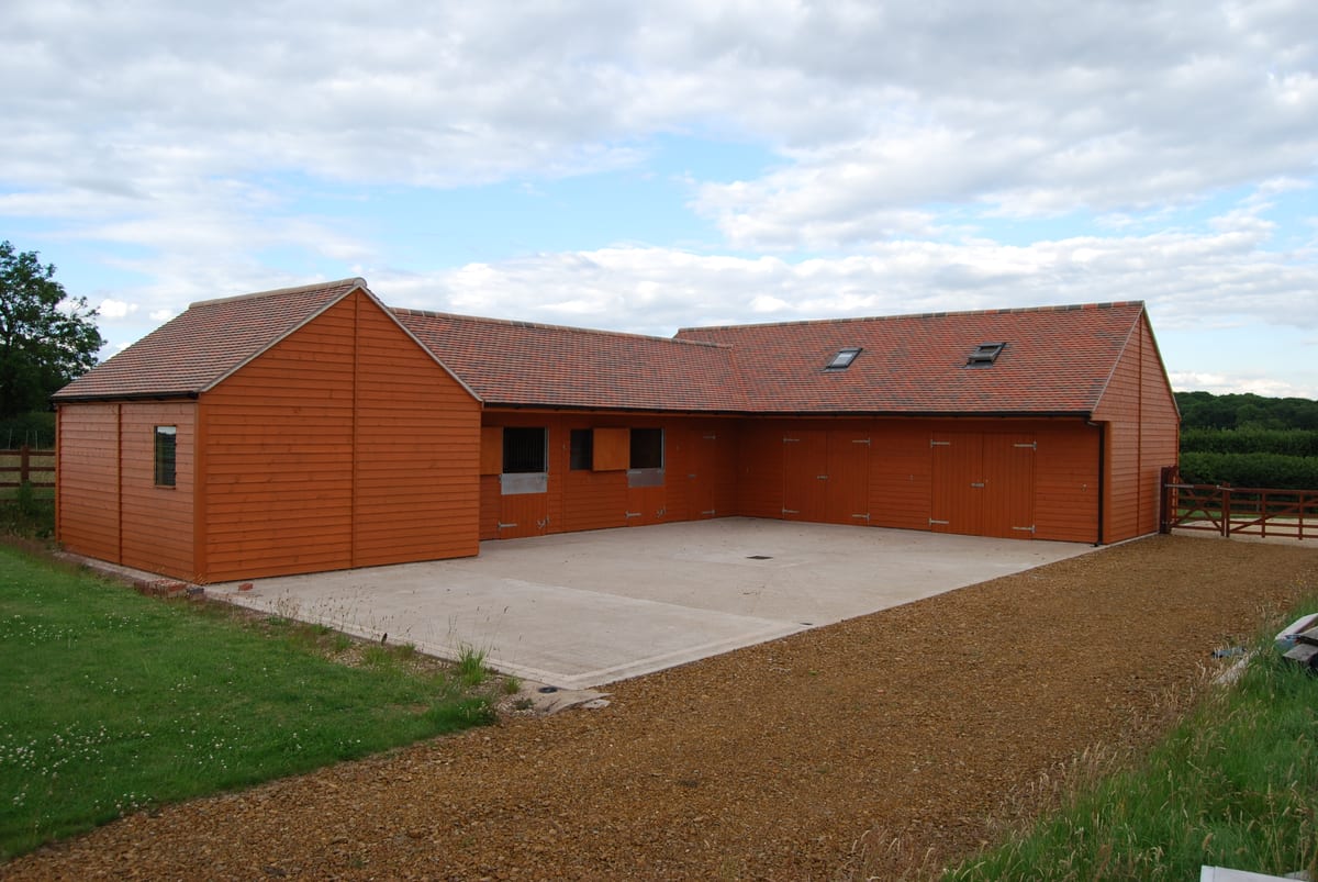Combination timber stables, tack room and garages with a peg tile roof